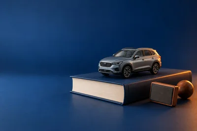 Модель автомобиля на закрытой книге и штамп